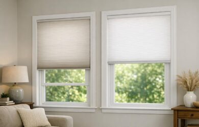 Close-up image of modern windows with cellular shades partially lowered in a comfortable living room, highlighting their insulating and light-filtering design without people present.
