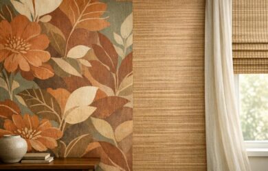 A professional stock photo of a modern room wall with 2026 wallpaper trends, featuring large botanical and textured designs in warm earthy colors, paired with neutral window treatments.